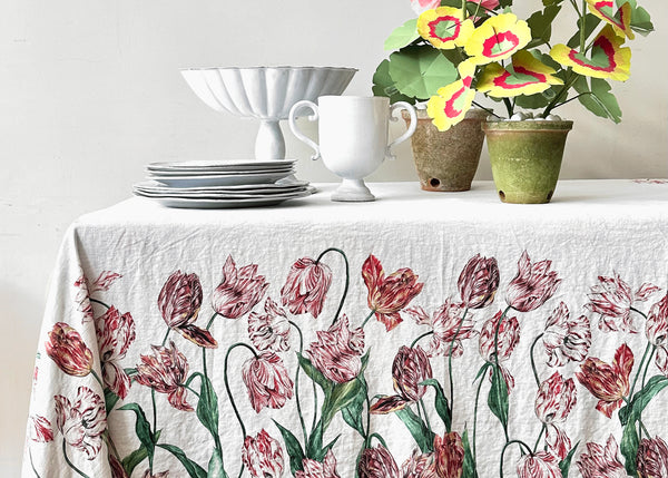Table with plates, flowers and tablecloth with tulips