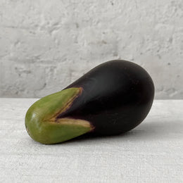 Marble eggplant sculpture on table