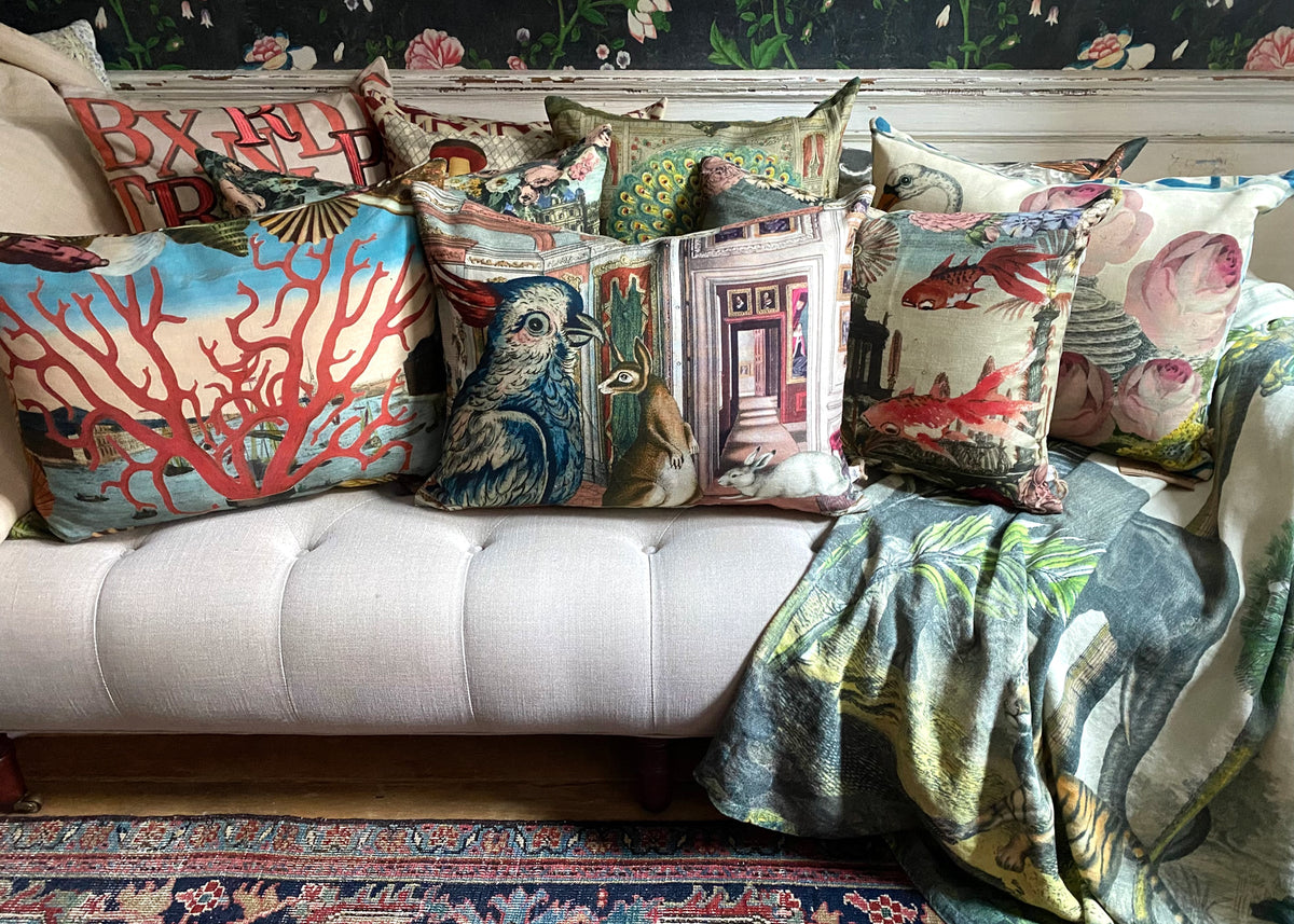 Group of pillows on a couch with throw