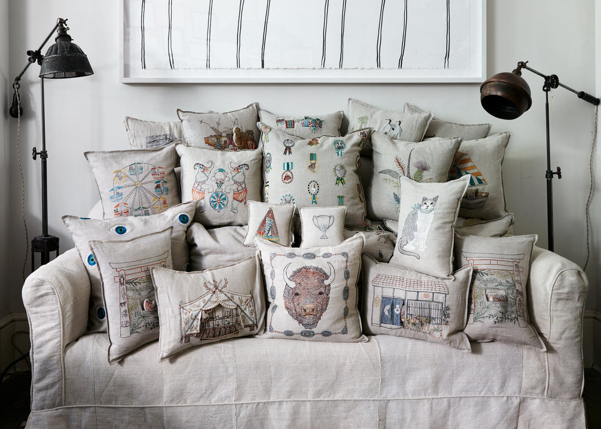 Group of embroidered pillows on a couch