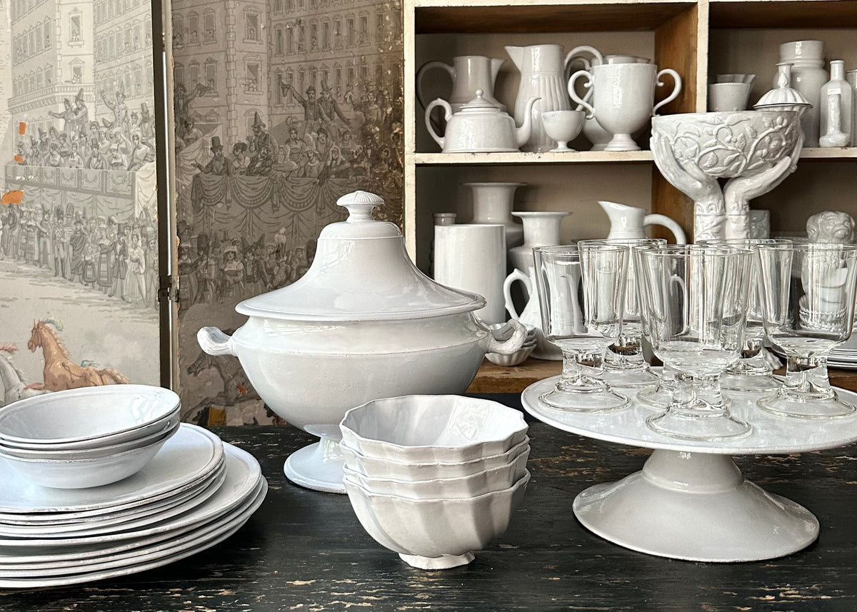 Image of white ceramic cups, vases, and pedestals