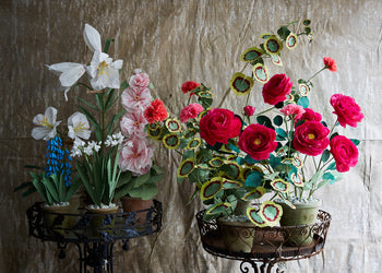 Group of intricately handmade paper flowers in pots