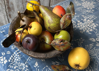 Collection of porcelain fruits & veggies on a table