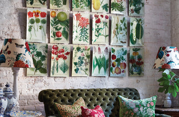 image of glass decoupage plates floral plates hanging on a wall above a couch with two lamps