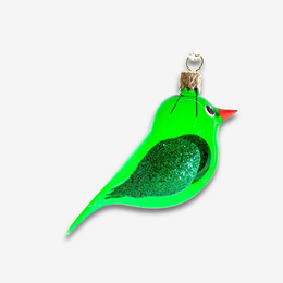 A green bird-shaped Christmas ornament with a glittery green body, a small red beak, and a silver hanging loop, shown on a light gray background.