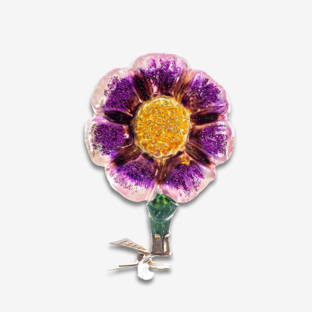 A vintage-style flower ornament with purple glittered petals, a yellow glittery center, and a green stem, shown on a plain light gray background.