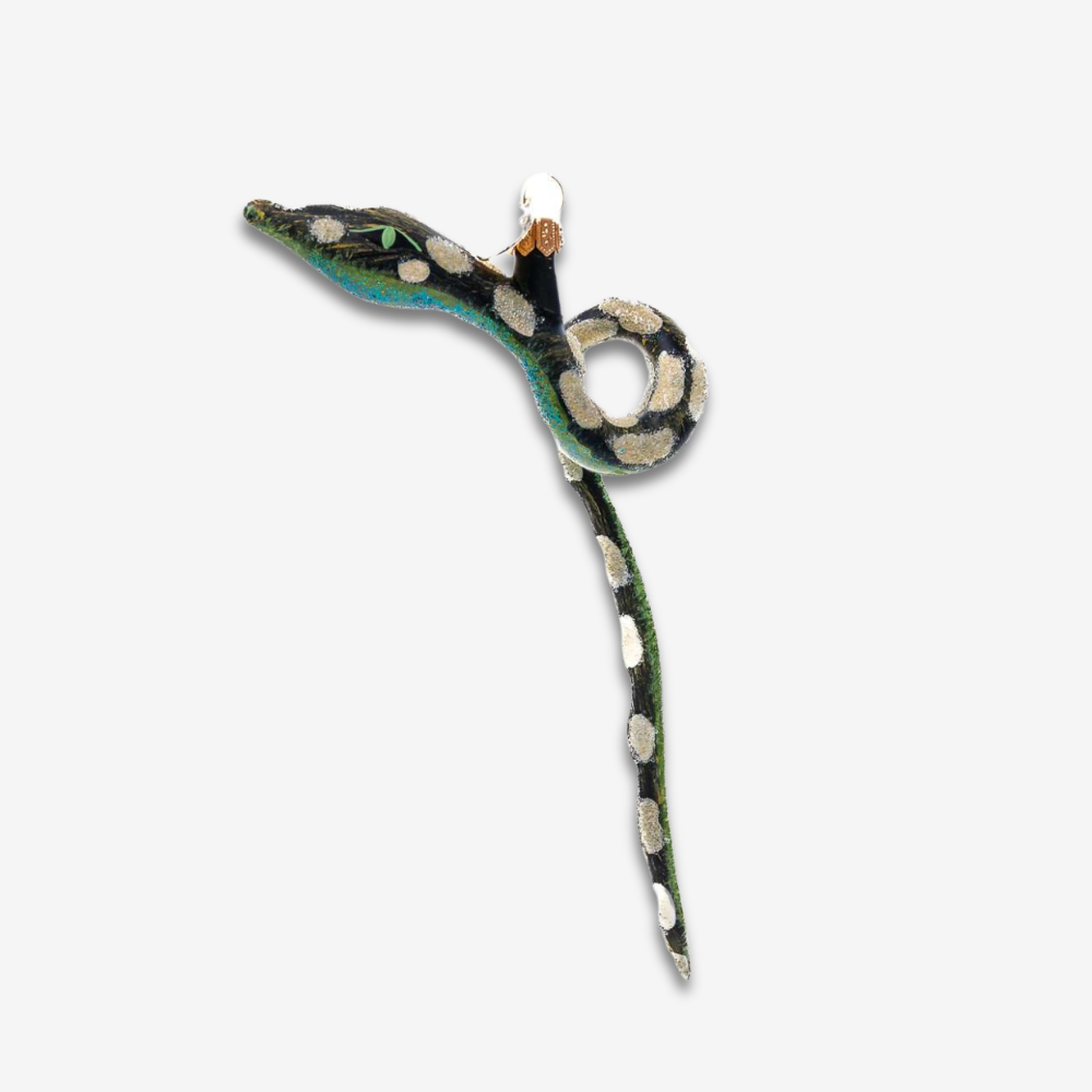 A snake-shaped ornament with a black body, green and white spots, and a turquoise-blue underside, shown on a plain light gray background.