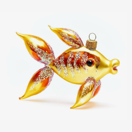 A gold fish-shaped Christmas ornament with red and orange accents and silver glitter details, shown on a clean white background.