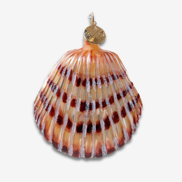 A decorative shell-shaped ornament resembling a scallop shell, with a gold hanging loop at the top, featuring amber, orange, and dark brown bands with silver crystalline accents, shown on a light gray background.