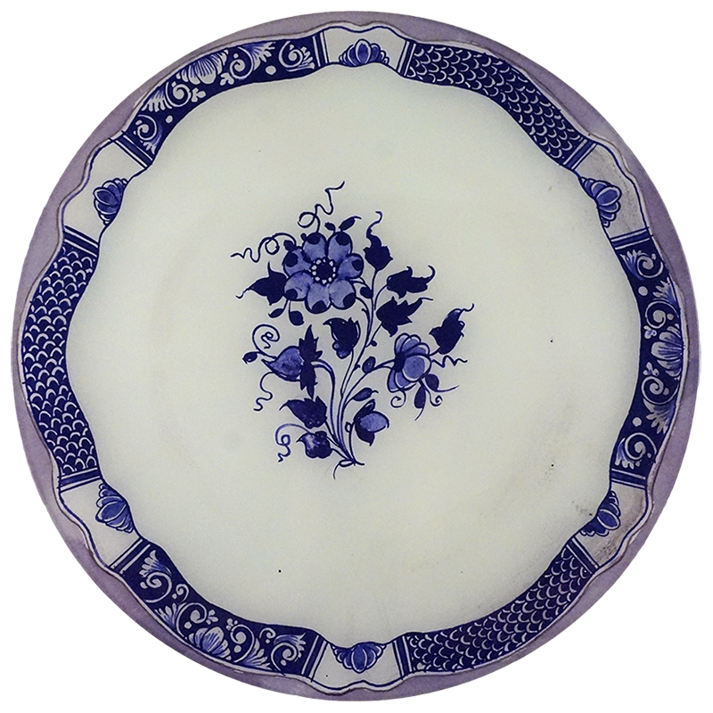 A 13-inch round glass plate featuring a blue sketch in the center of a white background and intricate blue boarder design. 