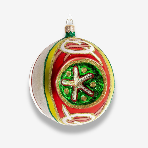 A round glass ornament painted red and green with a reflector in the center on back background 
