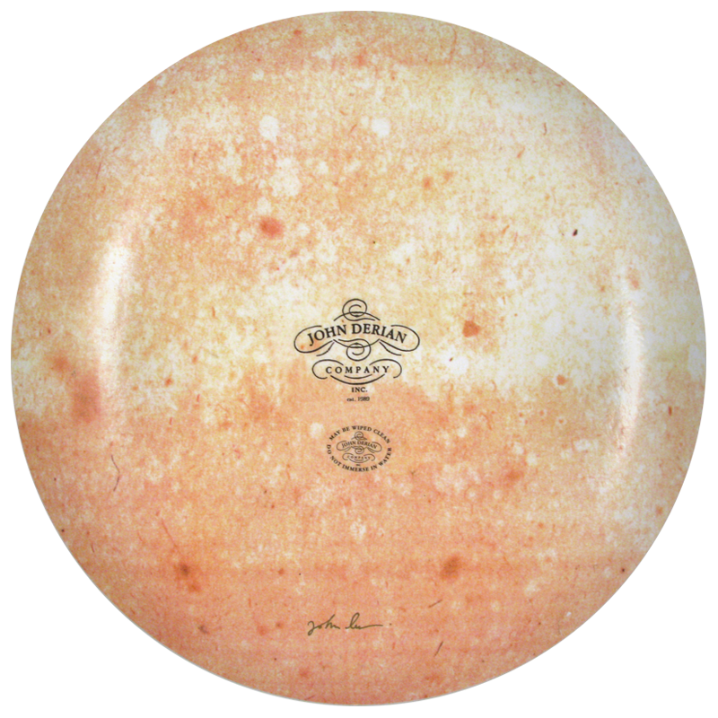 The back of an 16-inch round plate  featuring the signature John Derian Company sticker and signed by John Derian. 