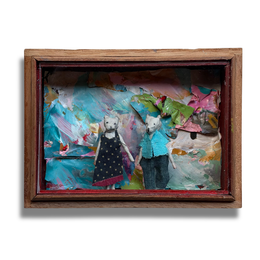 A rectangular wooden shadow wooden cigar box diorama display featuring two small white cat figurines holding hands, set against a colorful, textured collage background of paint splatters and paper pieces.