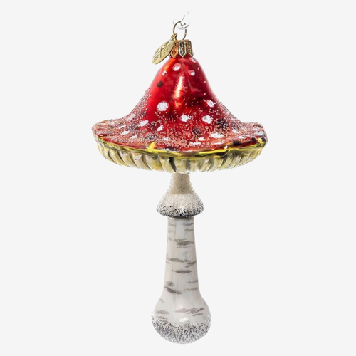 A decorative glass Christmas ornament shaped like a mushroom, featuring a glossy red cap with white speckles, a gold-rimmed edge, and a textured off-white stem with gray speckles, shown against a plain light gray background.