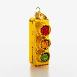 A gold glitter traffic light ornament with red, amber, and green glittery lenses, shown on a clean white background.