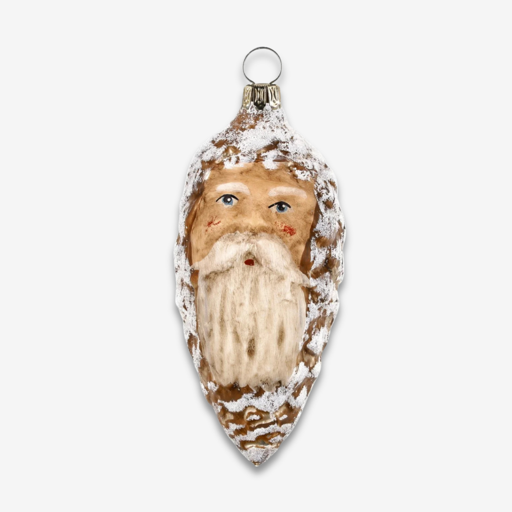 A hand-painted Christmas ornament shaped like Santa's face, featuring a brown wood-grain textured body, white faux-snow details, and a silver hanging loop at the top, shown against a light gray background.