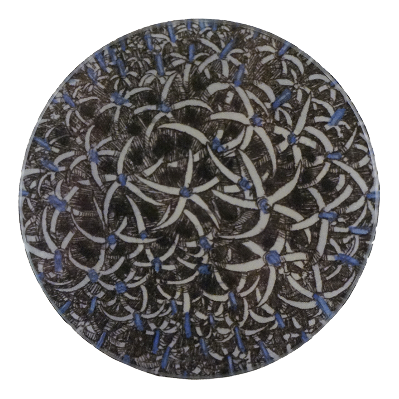A five inch round decorative plate with a floral pattern, featuring a combination of brown, blue, and white colors.