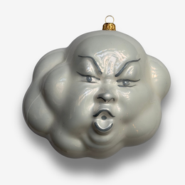Grey cloud-shaped ornament with gold features and face on white background