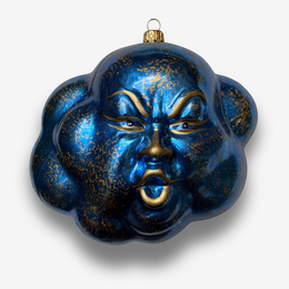 Blue cloud-shaped ornament with gold features and face on white background