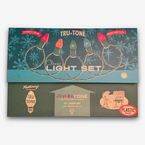 Vintage Jeweltone Tru-Tone plastic light set packaging, showing a teal and dark green box with illustrations of multicolored Christmas string lights and snowflakes.