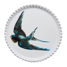 A round white ceramic plate with a scalloped beaded rim, featuring a detailed illustration of a flying swallow in blue, black, red, and cream on the front, set against a plain white background.