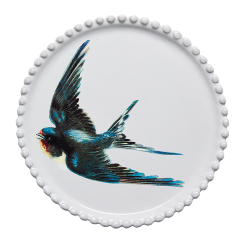 A round white ceramic plate with a scalloped beaded rim, featuring a detailed illustration of a flying swallow in blue, black, red, and cream on the front, set against a plain white background.