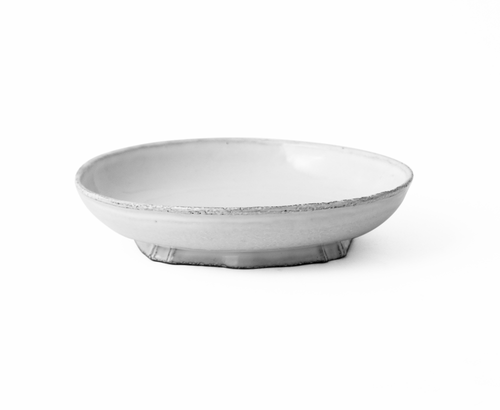 A small round pedestal dish with a textured, distressed white and gray finish, set against a solid white background.