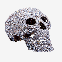 Crystal-shaped skull made from rhinestones on a neutral background 