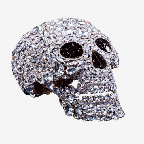Crystal-shaped skull made from rhinestones on a neutral background 