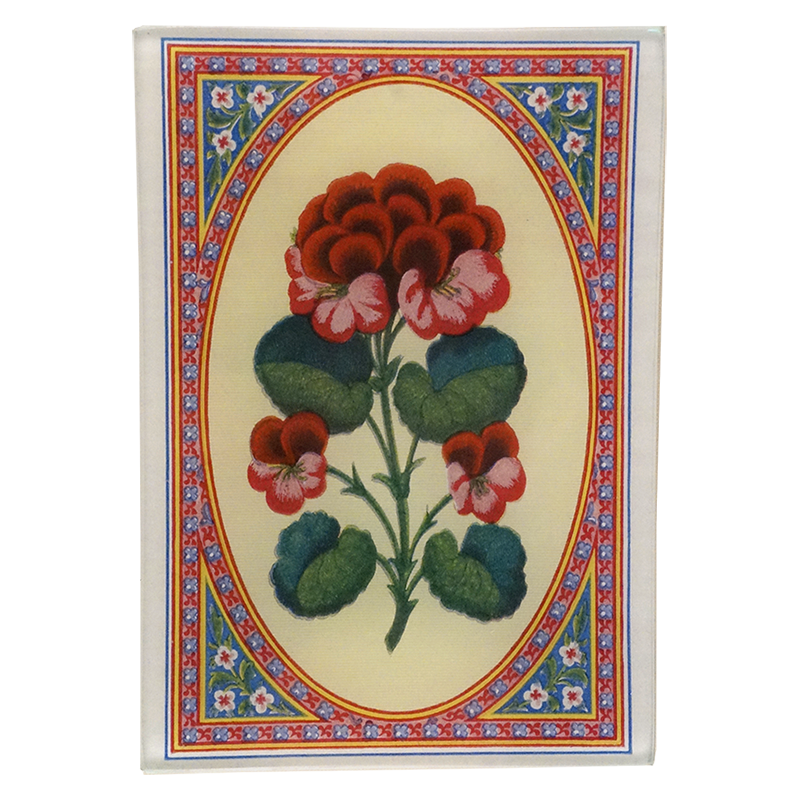 A floral design with red and pink flowers and green leaves, bordered with a decorative pattern on a four and a half inch by six and a half inch glass tray. 