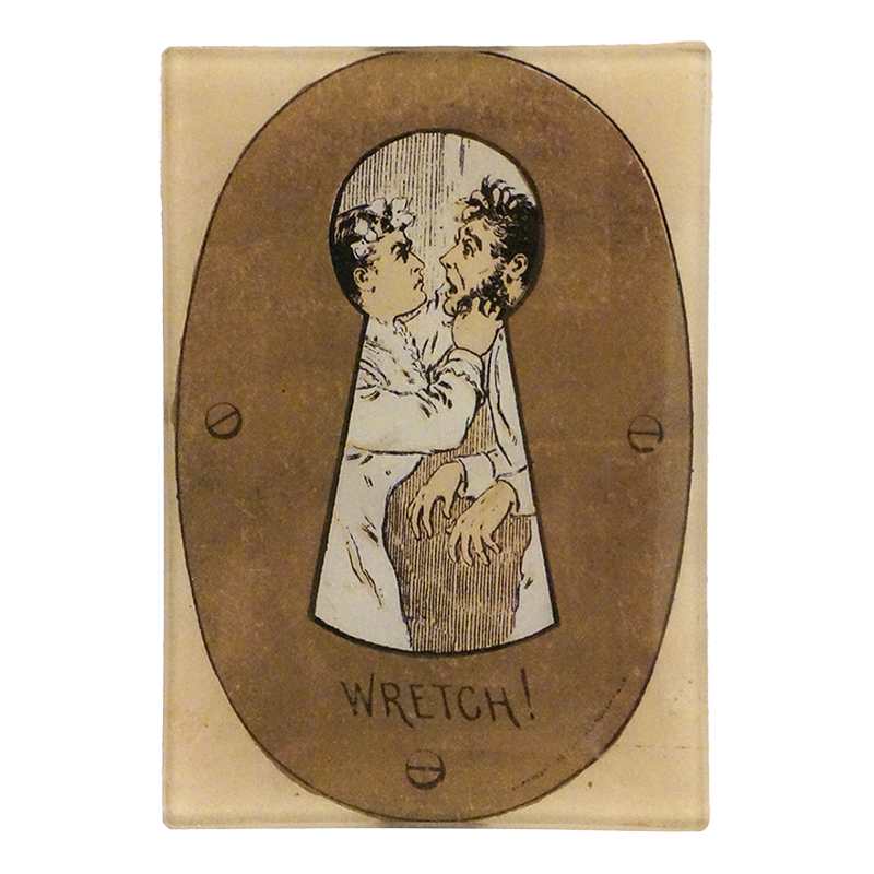 A three and a half inch by five inch vertical rectangle glass tray with a keyhole-shaped illustration showing two figures, one with a flower in its hair, on a tan background with the word 'WRETCH!' printed below.