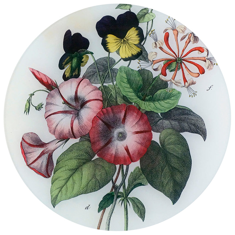 An eleven inch round glass plate featuring a collage of different flowers on a white background. 