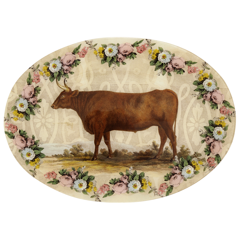 A thirteen inch by eighteen inch horizontal oval glass plate of a brown bull surrounded by a floral boarder. 
