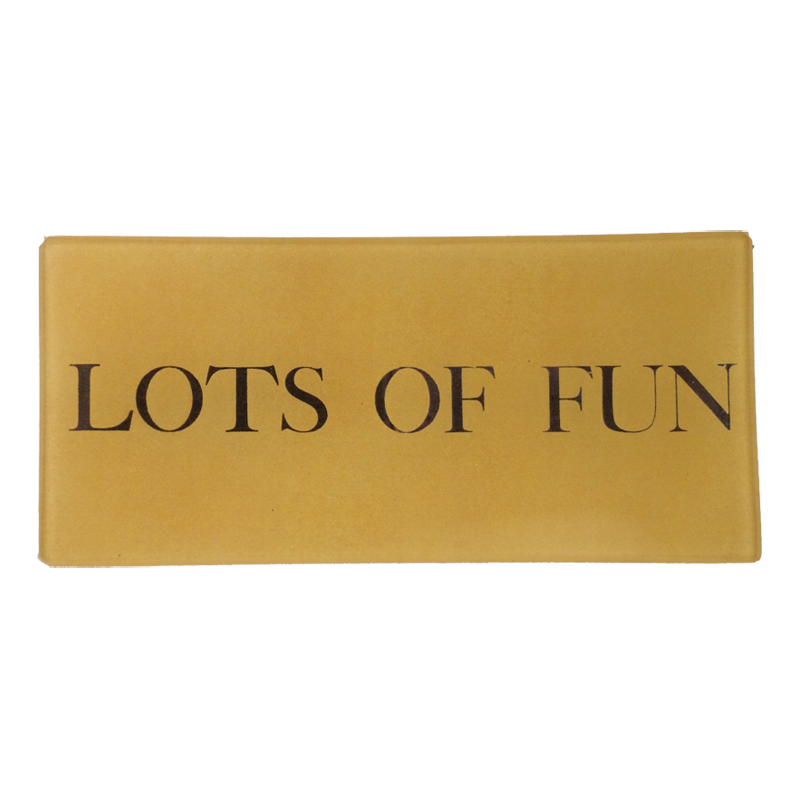 The text 'LOTS OF FUN' in bold black letters on a three and a half inch by seven inch glass tray.