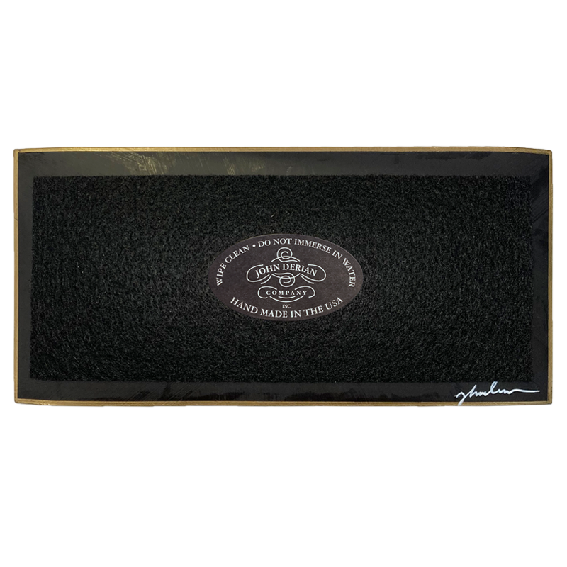 The back of a three and a half inch by seven inch that is painted black, with back felt, a gold trim and the John Derian Company logo sticker, signed by John Derian. 