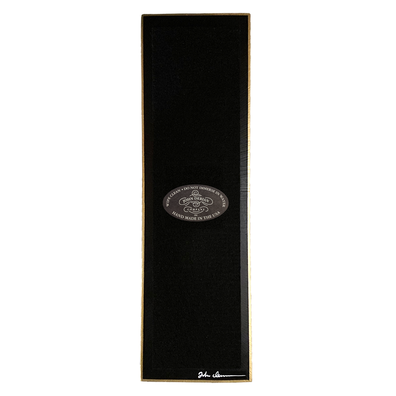 The back of a three and a half inch by twelve inch that is painted black, with back felt, a gold trim and the John Derian Company logo sticker, signed by John Derian. 