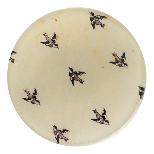 A four inch round handmade decoupage plate titled In Flight