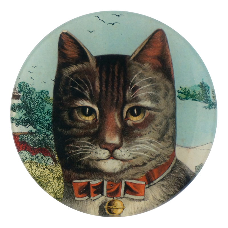 A five inch round glass plate featuring a collage of a cat's face wearing a red bow with a gold bell. 