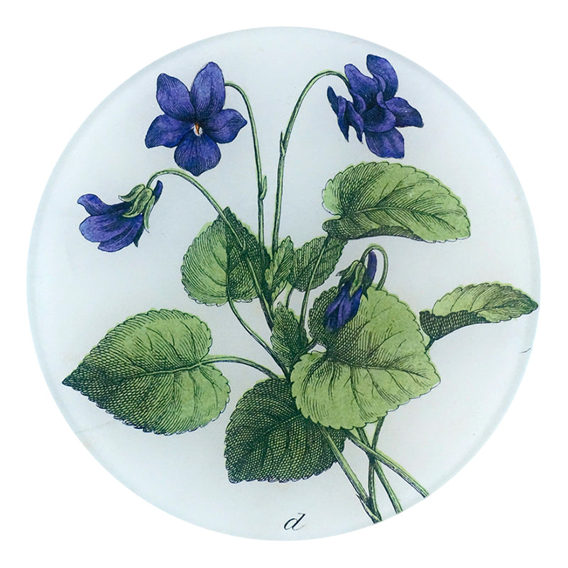 A five inch round glass plate featuring a collage of purple violets and green leaves.
