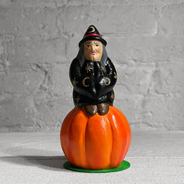 Witch Sitting on Small Pumpkin