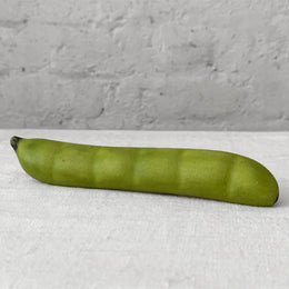 Marble green bean sculpture on table