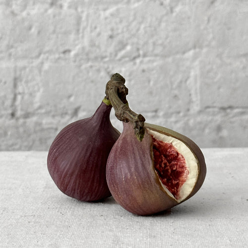 Porcelain fig sculpture on table