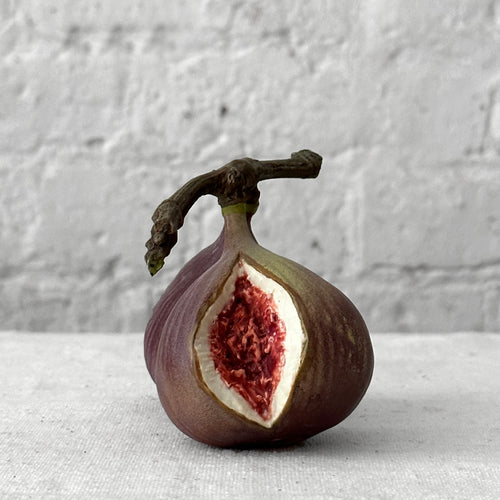 Porcelain fig sculpture on table