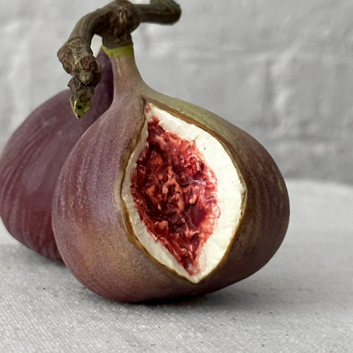 Porcelain fig sculpture on table